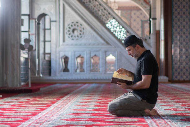 Muslim man reciting Quran in the Mosque