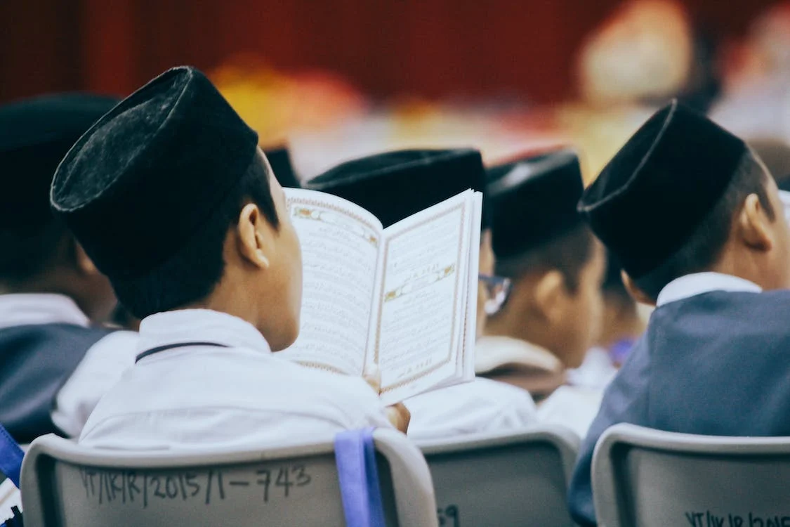 Group of Muslim children reciting Quran together