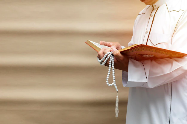 A Muslim man holding the Holy Quran