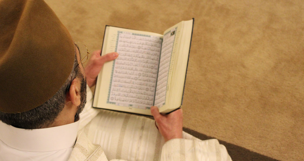 A Muslim man memorizing a Surah of the Holy Quran